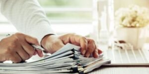 Manos revisando documentos importantes para inmigración a Canadá