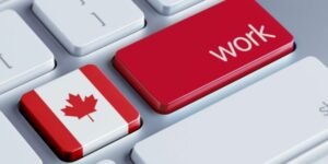 Teclado de computadora con la bandera de Canadá y la palabra Work destacada en rojo